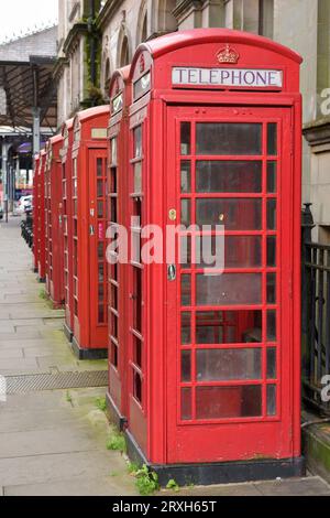 Old red telephone boxes on Market Street in the Cirt of Preston. Stock Photo