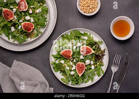 Food photography of salad; goat cheese; fig; feta; leaf; lettuce; rocket; pine; nut; honey Stock Photo