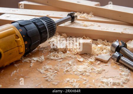 Timber, wood shavings and carpentry tools on a work bench. Stock Photo