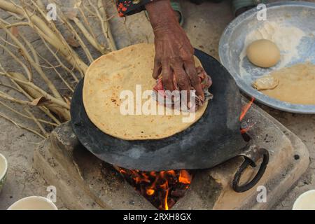 Making roti (Indian Chapati) on roti tawa made of wheat with hand Stock ...