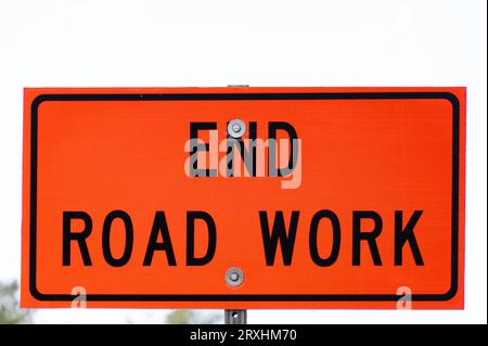 Orange sign indicating the end of road work area Stock Photo