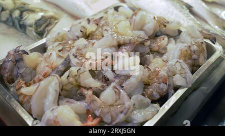 fresh de-shelled shrimp meat in a iron plate. peeled-off raw material for cooking Stock Photo