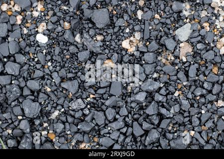 Black coal stones and pebbles from a coal store, Texture background for design, Coal stone texture background Stock Photo