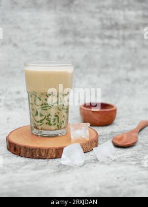 es cendol dawet or iced sweet dessert that contains droplets of green rice flour jelly, coconut milk and palm sugar syrup. Stock Photo