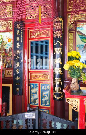 Vietnam: A door next to the 12 Midwives altar, Fujian (Phuc Kien) Assembly Hall, Hoi An. Phuc Kien is the Vietnamese for Fujian, and this, the richest of the several Chinese Assembly Halls in Hoi An, was founded by merchants from Fujian Province. It also serves as a temple dedicated to Thien Hau, a goddess who specially cares for seafarers like the Fujian merchants in times past. The historic town of Hoi An is located on the Thu Bon River 30km south of Danang. During the time of the Nguyen Lords (1558 - 1777) and under the first Nguyen Emperors, Hoi An was an important port. Stock Photo