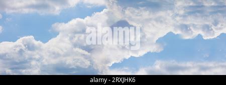 A panoramic view of the sky full of heavy clouds in white and gray. Stock Photo