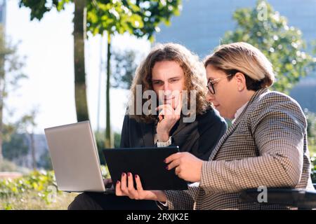 businessman and businesswoman working outdoors Stock Photo