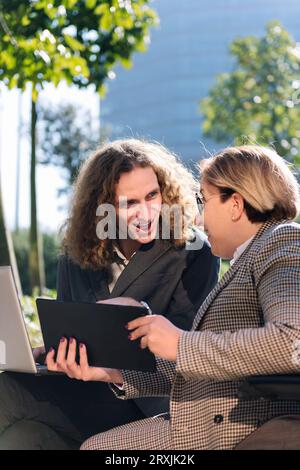 businessman and businesswoman working outdoors Stock Photo
