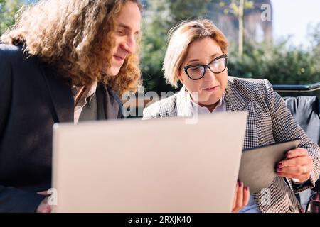 businessman and businesswoman working outdoors Stock Photo