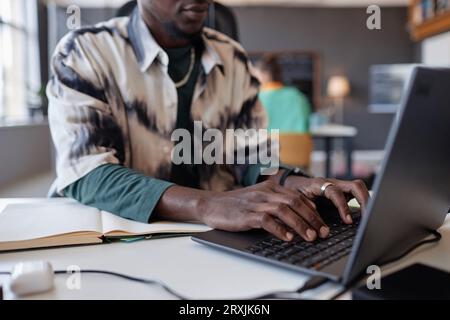 Close-up of African American Programmer typing on laptop in office Stock Photo