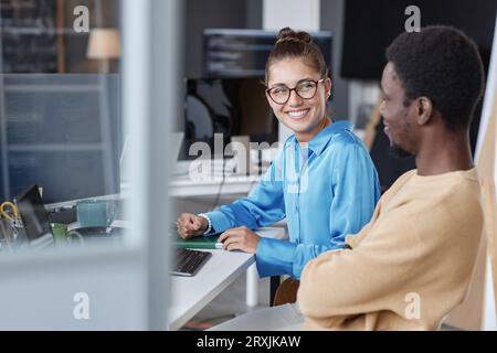 Couple of young programmers working with software on computer in team in IT office Stock Photo
