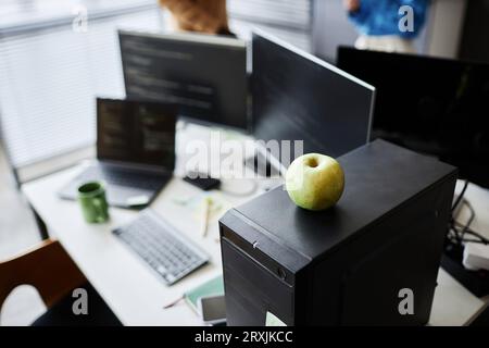 High angle view of workplace of programmer with computers and green apple Stock Photo