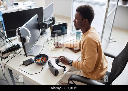 High angle view of African American programmer developing software in office Stock Photo
