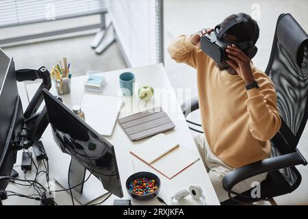 High angle view of African American programmer testing VR glasses in office Stock Photo