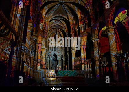 A view of the Nave at Canterbury Cathedral in Kent during a preview of the Luxmuralis: Renaissance, an art installation using moving light displays and original compositions to highlight the cathedral's architecture and immerse visitors in paintings and artwork from the Renaissance period during the Canterbury Festival. Picture date: Monday September 25, 2023. Stock Photo