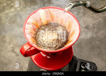 Serves coffee with a V60 dripper coffee maker on the table Stock Photo