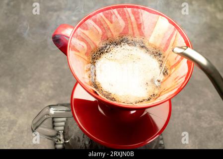 Serves coffee with a V60 dripper coffee maker on the table Stock Photo