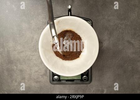 Serves coffee with a V60 dripper coffee maker on the table Stock Photo