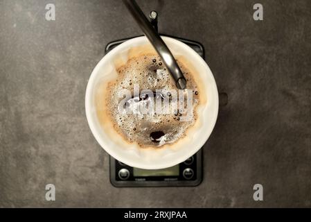 Serves coffee with a V60 dripper coffee maker on the table Stock Photo