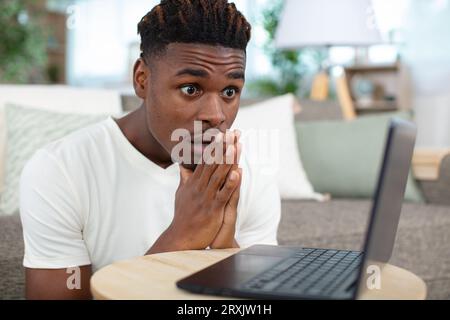 man looking at computer screen in shock Stock Photo