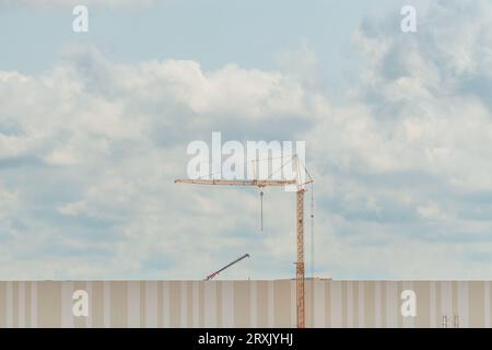 Construction crane on building site, industry and architecture concept, minimalistic composition Stock Photo