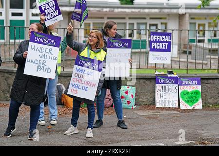 School support workers, who are members of Unison, on the picket line at Holy Cross RC Primary School in Edinburgh. Essential school staff including cleaners, janitors and support workers have been locked in a pay dispute, with a new offer estimated to cost £580 million. Picture date: Tuesday September 26, 2023. Stock Photo