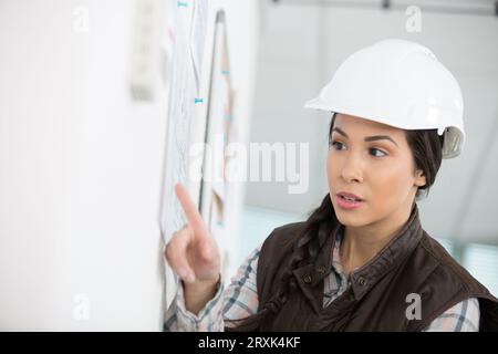 a female builder is checking the planning Stock Photo