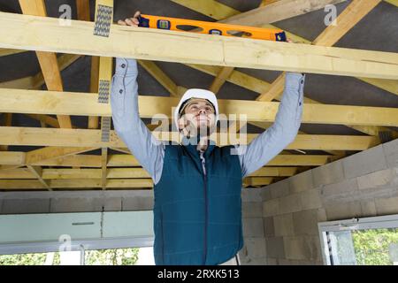 carpenter using a spirit level on wood Stock Photo