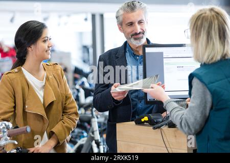 couple looking for bicycle in bike shop Stock Photo