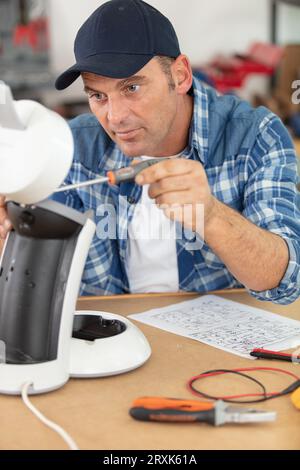 professional young worker fixing coffee machine Stock Photo