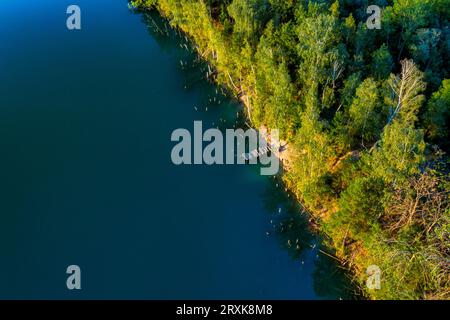 Summer's Secrets Unveiled: Discovering the Hidden Charms of a Forest Lake, High Above the Treetops Stock Photo