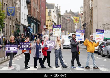 School support workers, who are members of Unison, on the picket line at Royal Mile Primary School in Edinburgh. Essential school staff including cleaners, janitors and support workers have been locked in a pay dispute, with a new offer estimated to cost £580 million. Picture date: Tuesday September 26, 2023. Stock Photo