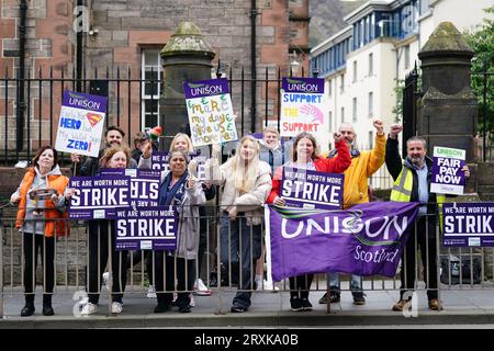 School support workers, who are members of Unison, on the picket line at Royal Mile Primary School in Edinburgh. Essential school staff including cleaners, janitors and support workers have been locked in a pay dispute, with a new offer estimated to cost £580 million. Picture date: Tuesday September 26, 2023. Stock Photo