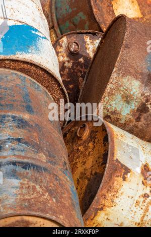 abstract of rusty old scrapped oil drums or barrels. scrapheap of old corroded oil cans and oil drums. Stock Photo