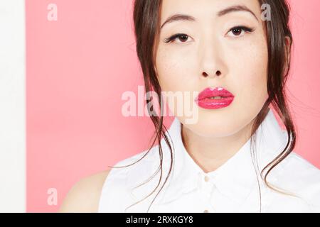 Young woman wearing pink lipstick Stock Photo