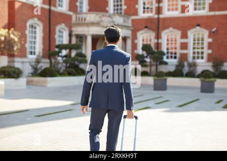 Rear view of businessman walking Stock Photo