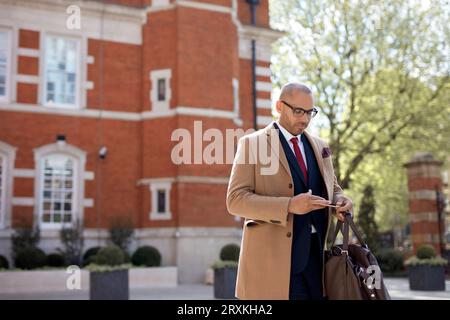 Businessman text messaging on smart phone Stock Photo