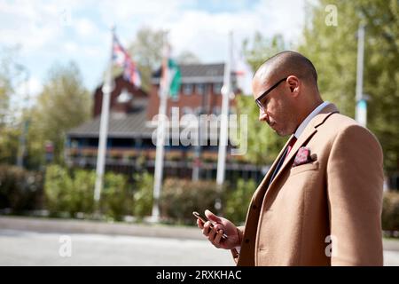 Businessman text messaging on smart phone Stock Photo