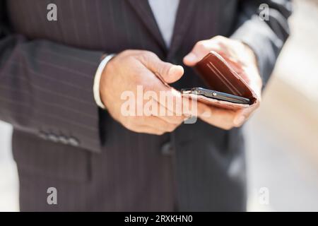 Hands of businessman using smartphone Stock Photo