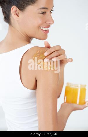 Woman applying body scrub Stock Photo