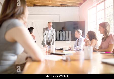 Mature businessman talking during meeting in office conference room Stock Photo