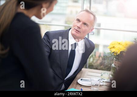 Businesspeople talking during a restaurant meeting Stock Photo
