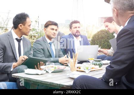 Businesspeople using laptop and tablet PC in restaurant Stock Photo