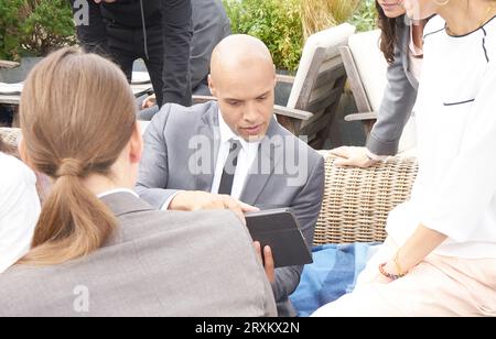 Businesspeople using tablet PC at restaurant meeting Stock Photo
