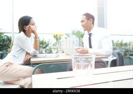 Businesspeople using laptop during restaurant meeting Stock Photo