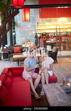 Young couple toasting on sofa Stock Photo