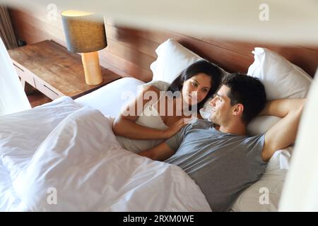 Young couple lying in bed Stock Photo