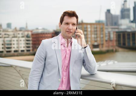 Mid adult man on phone in city Stock Photo