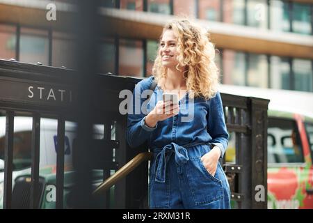 Young woman holding smart phone Stock Photo