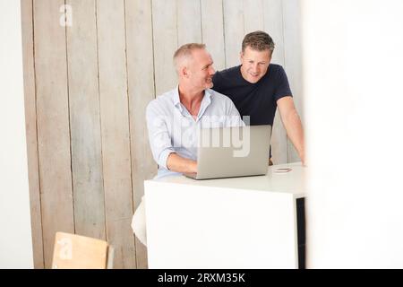 Gay couple using laptop Stock Photo